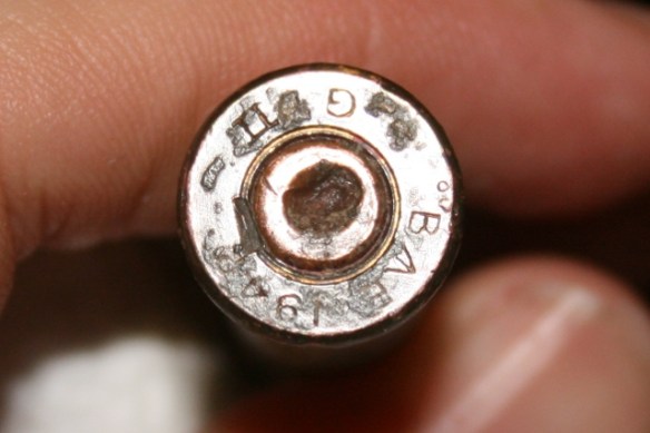 Writing on headstamp just about fully revealed; red paint just about lost.
