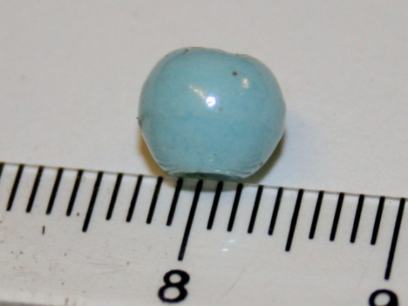Lucite(?) bead from floor of trench 1B