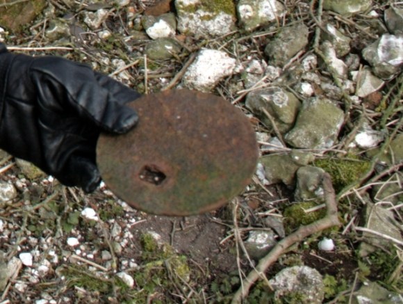 Cast iron lid of stove found on surface of rubble mound