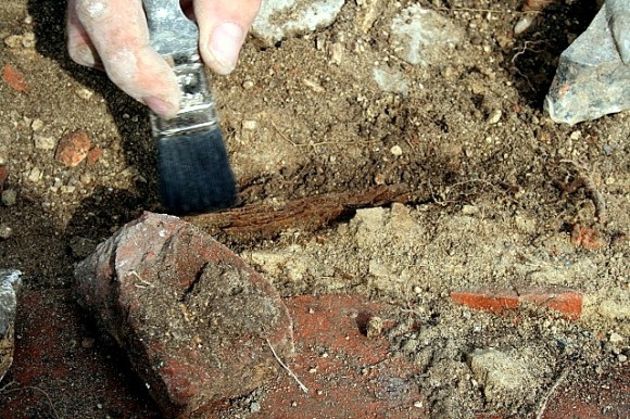 Excavating a fragment of wood - possible stair remnant