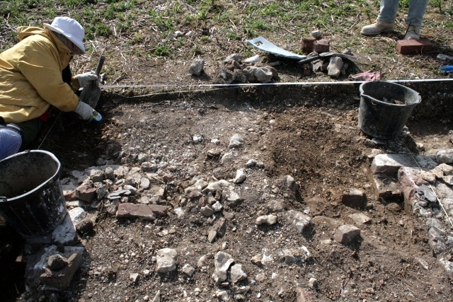 Partial excavation of W wall of lean-to-structure to S of house