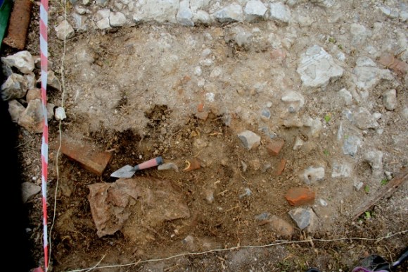 Metal container in SE quadrant of grid square in front of house
