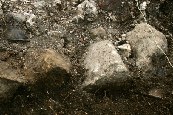 Demolition rubble in vicinity of outside toilet