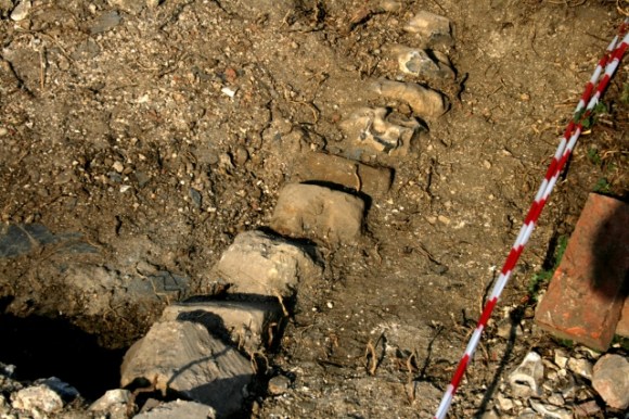 Stones edging N side of path E of toilet showing possible turn towards front gate