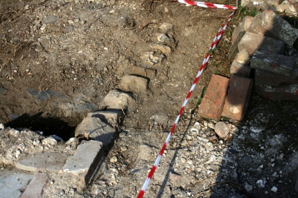 SE corner of toilet and N edge of garden path