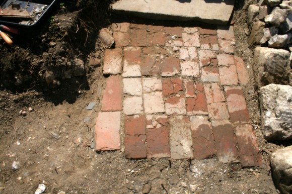 Photo of brick paved path taken from path junction; facing direction of front door (top), with toilet off to the right and front garden gate off to the left