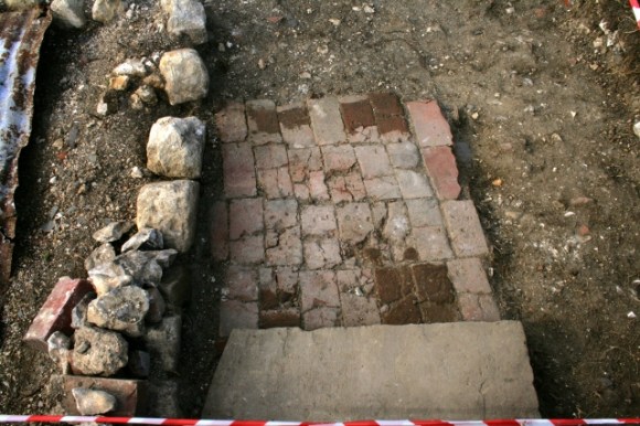 Looking N from front door across stone step and brick paved path
