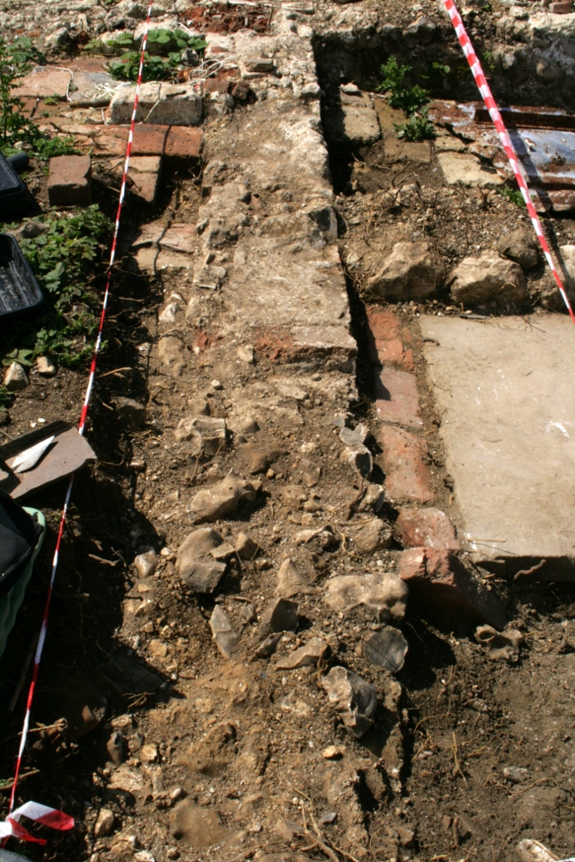 Looking W across front wall of house