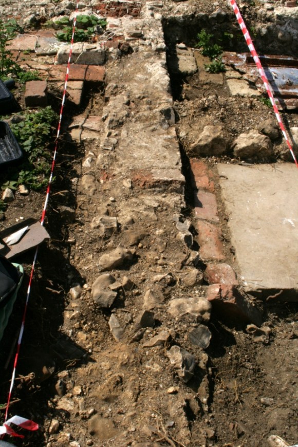 Looking W across front wall of house