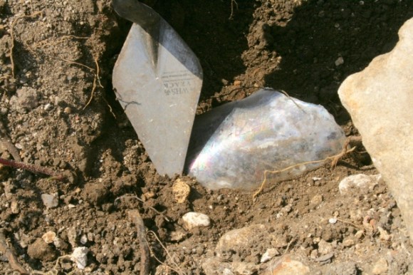Rainbow patina on old glass bottle shard