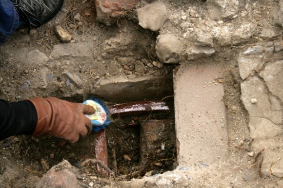 Looking S at drain in front of house at junction of scullery/kitchen and wood-store 