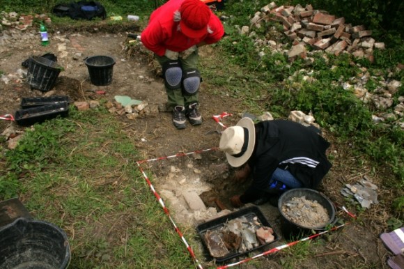 Ceramic drain in front of junction of scullery/kitchen and woodstore