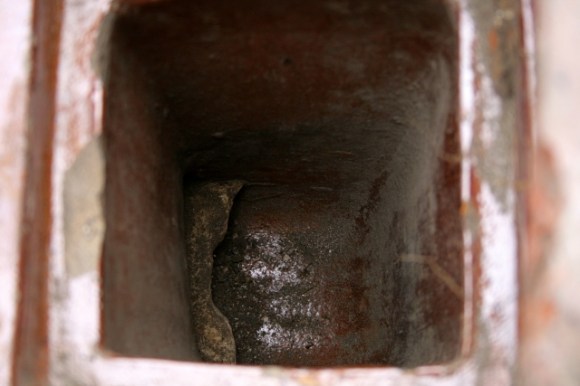 Looking down gulley drain with openings to east
