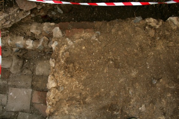 Looking E, down onto the N & E part of concrete platform & top of bulldozer cut S wall of 'woodstore'