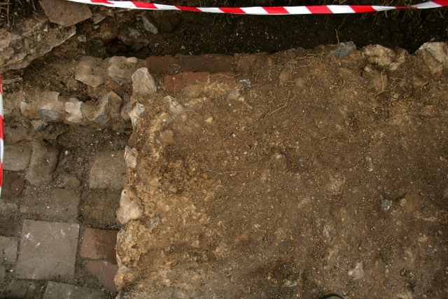 Looking E, down onto the N & E part of concrete platform & top of bulldozer cut S wall of 'woodstore'