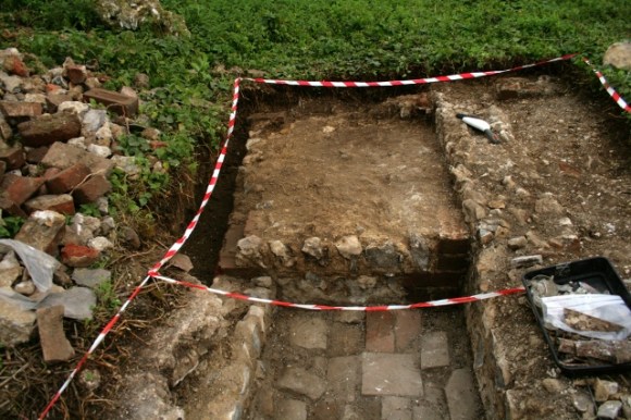 Looking S at concrete platform S of 'woodstore' E of scullery/kitchen