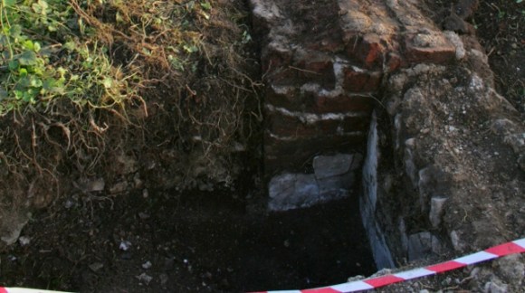 Looking S at N side of chimney base on E side of cottage