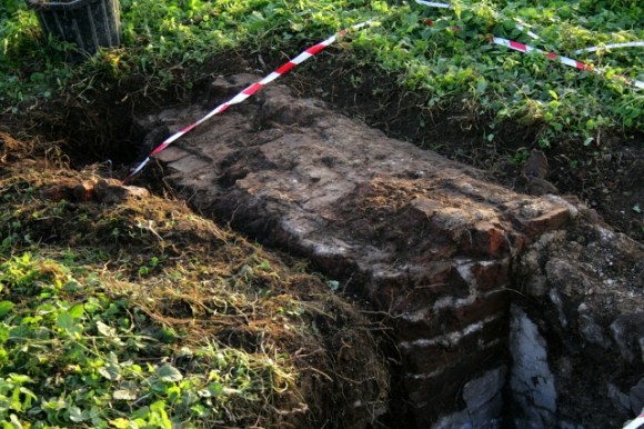 Looking SW at chimney base on E side of cottage
