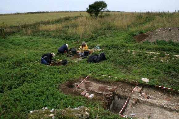 Looking SW at E and S sides of cottage from demolition rubble mound