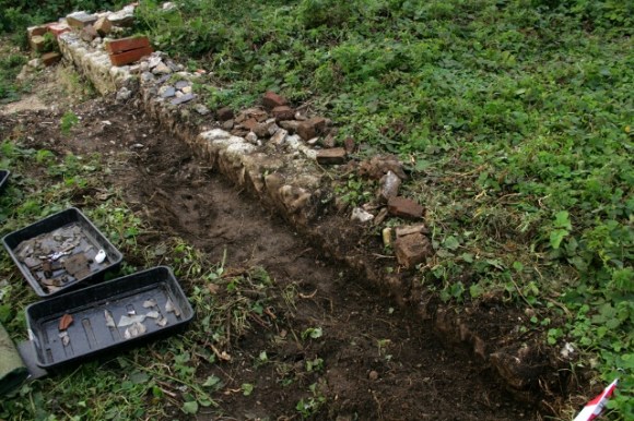 Loking NW at S wall of cottage