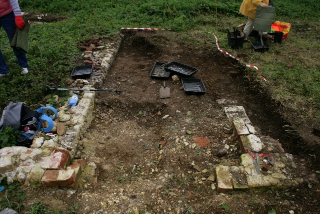 Looking E at extension against W part of S end of cottage