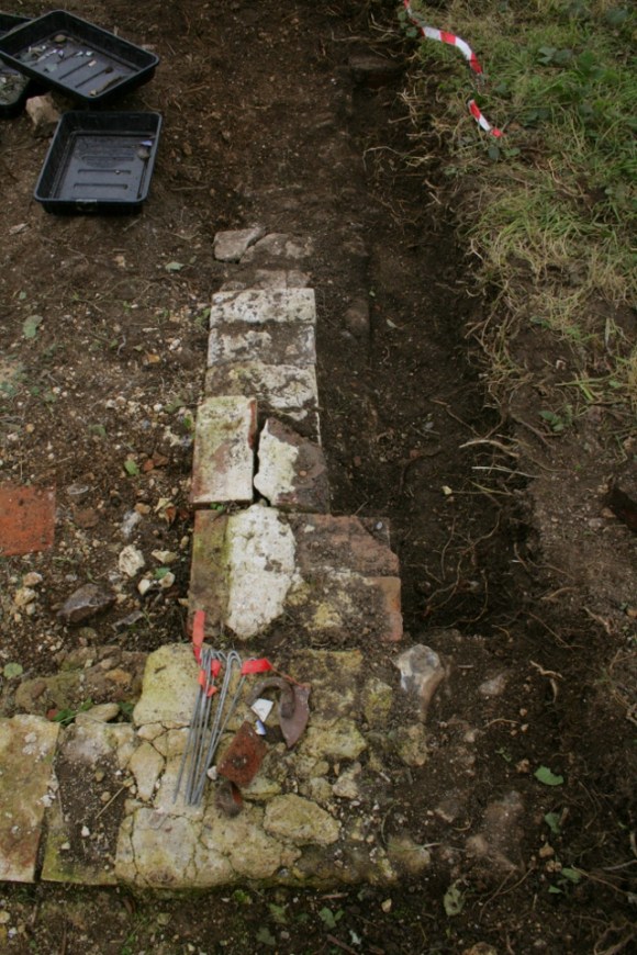 Looking E at S wall of cottage extension