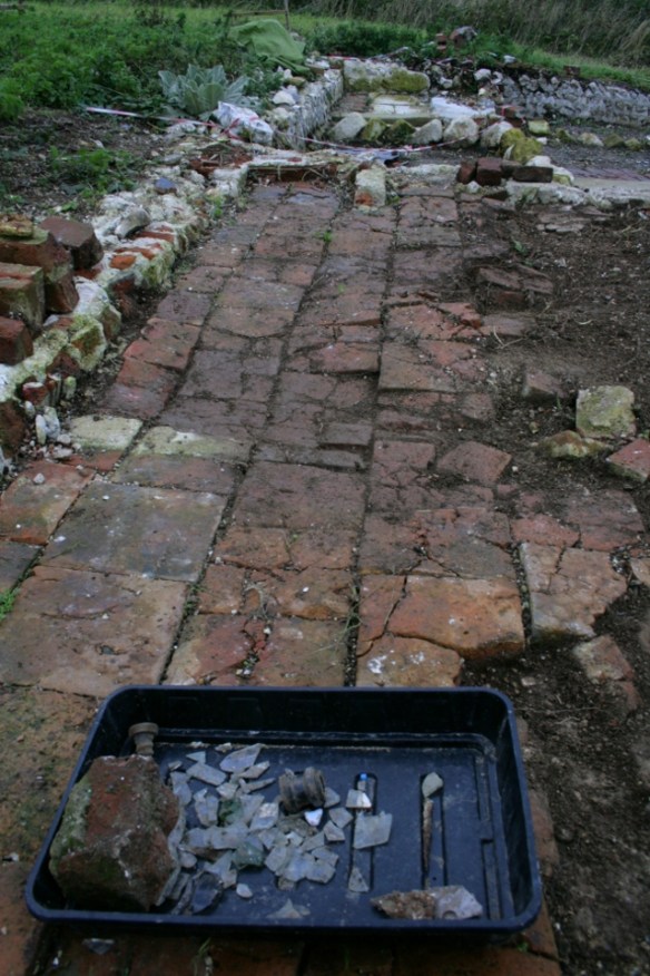 Looking N at surviving floor of N end of cottage