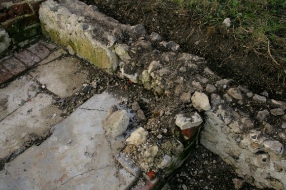 Looking NW at N wall of outside toilet damaged by ponies