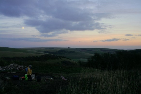 Loking E at sunset and full moon over dig site and Castle Hill NNR