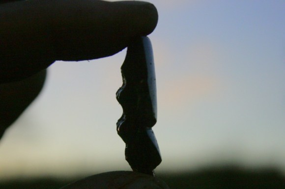 Broken top of a bottle with internal screw thread on left hand side for rubber stopper