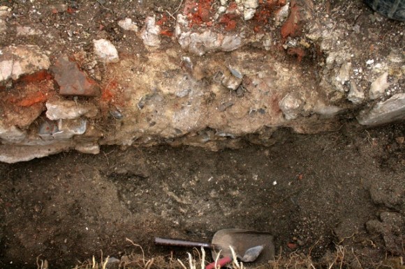 Looking W at WW2 ordnance damage to E wall of cottage
