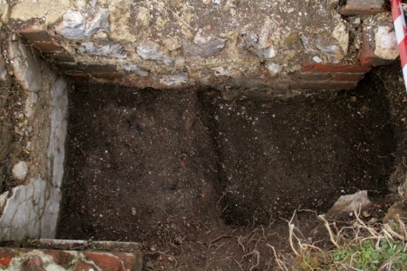Looking N at gap between bases of chimney and 'laundry copper'