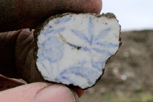 Light blue and white decorated ceramic shard