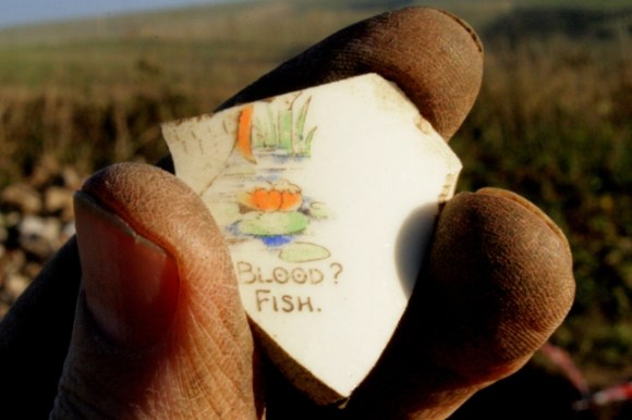 Shard of cup decorated with verse from 'Who Killed Cock Robin'