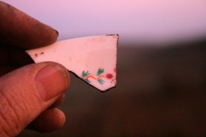Ceramic shard, in late afternoon sun, from excavation of demolition rubble from E of chimney base; 8th December 2013.
