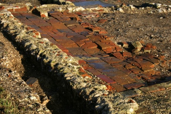Looking NE at terracotta floor in N room of cottage