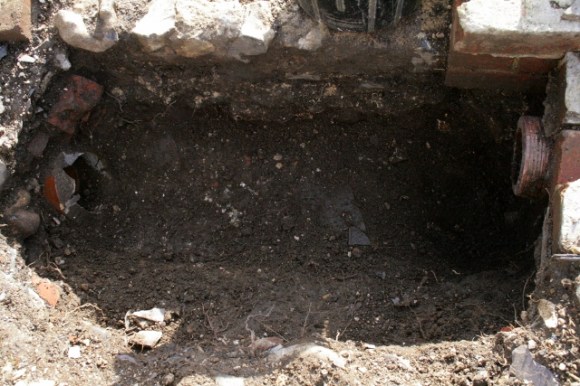 Looking S at construction trench for drain in front of shed