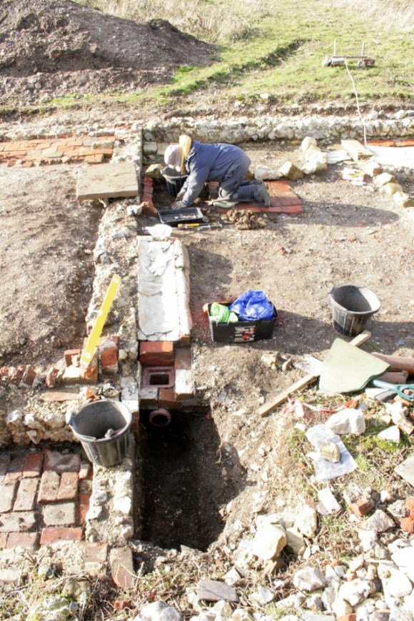 Looking E at gully drain in front of cottage