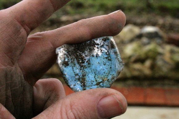 Aluminium foil milk bottle top from foundations of outside toilet