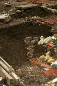 Looking SW at excavation of cobbled flint surface from front front garden gateway to front doorstep of cottage; 9th February 2014