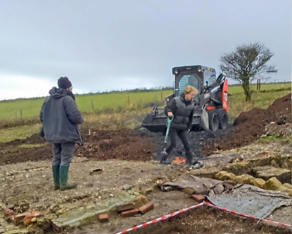 Looking SW at backilling of dig site