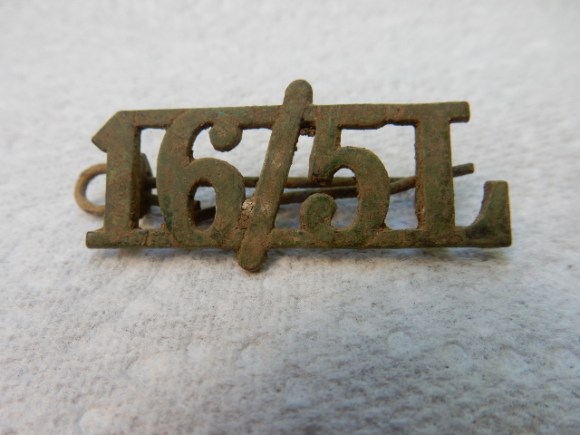 16th and 5th Queen's Royal Lancers 'Shoulder Title' excavated from demolition rubble, Newmarket Farm.