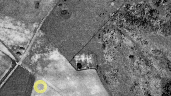 WW2 aerial photograph of Newmarket Farm, including enhanced plough mark of possible Bronze Age barrow.
